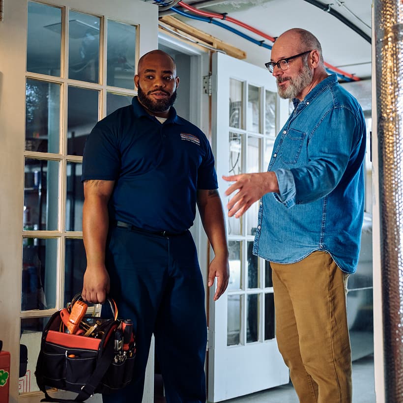 A Horizon technician discusses the home repair and installation service with the homeowner.
