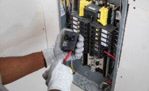 A technician working on an electrical panel