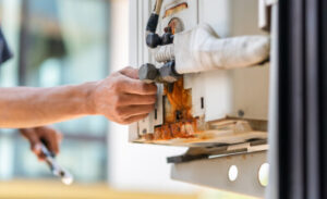 A technician looks at connections on an HVAC system